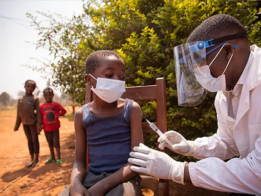 An image of a doctor with a little boy in Africa 