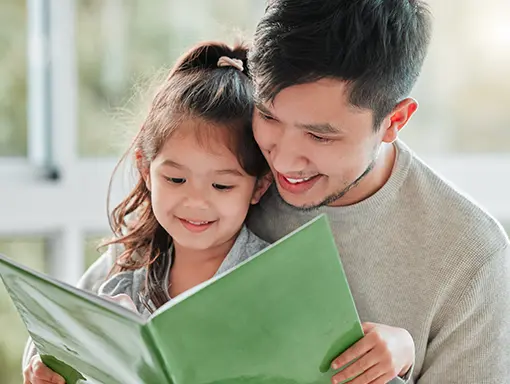 An image of a man teaching a child how to read